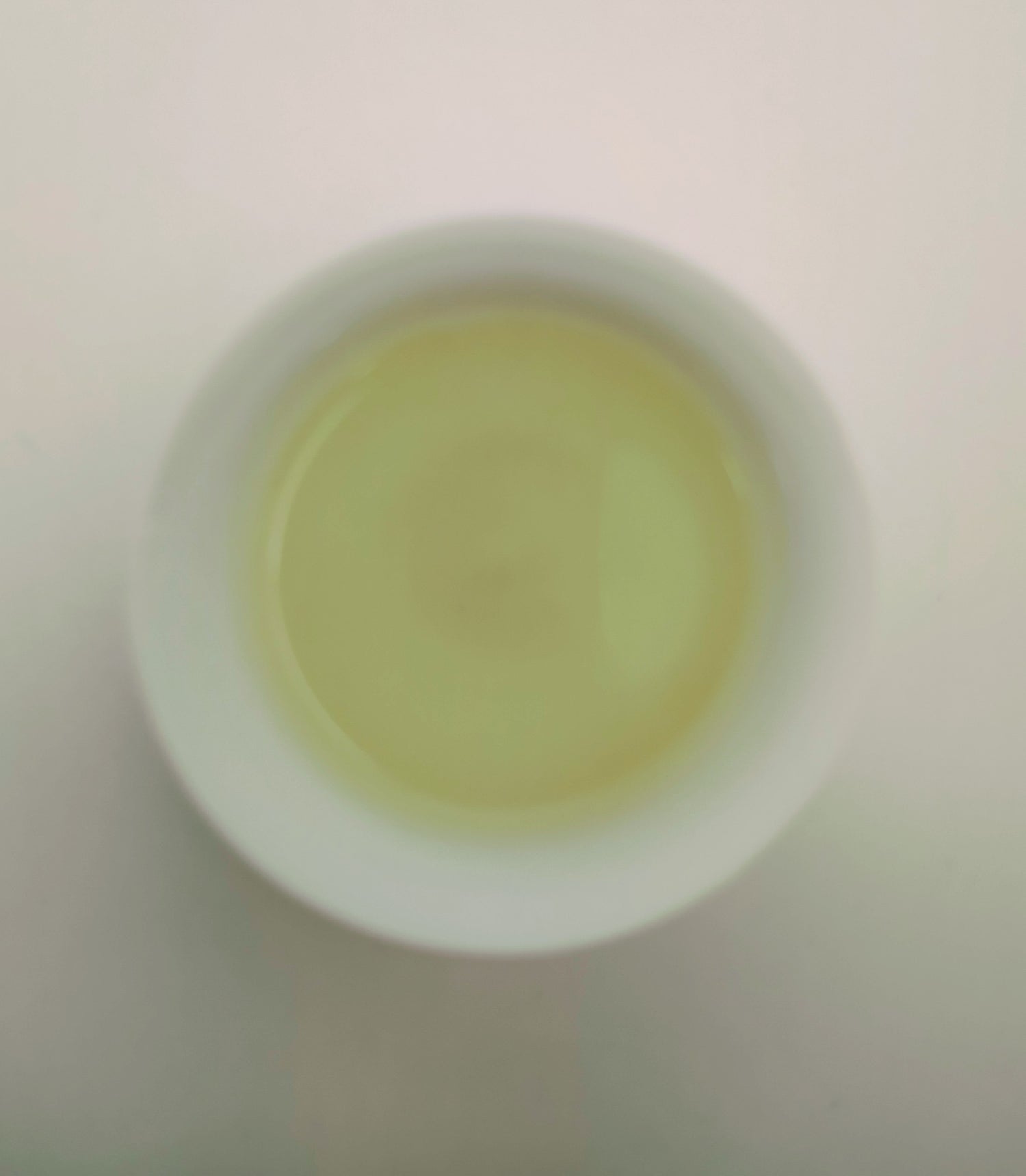 Picture of brewed green tea in a small cup, Yun Wu.